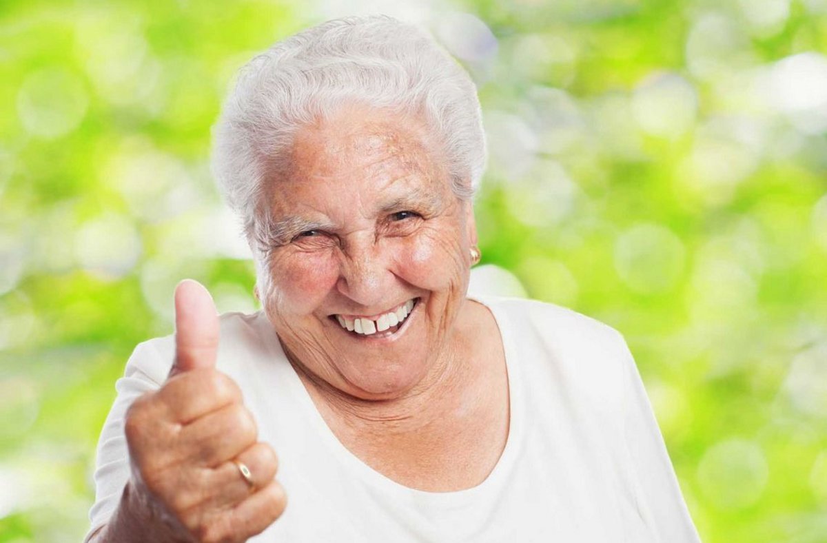 Mamie souriante qui a le pouce levé