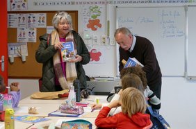 Distribution d'un livre aux élèves par les élus